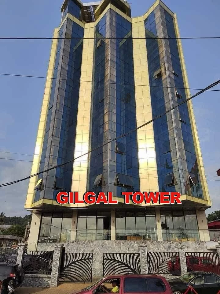Gilgal Tower signage on the gold-and-blue glass facade